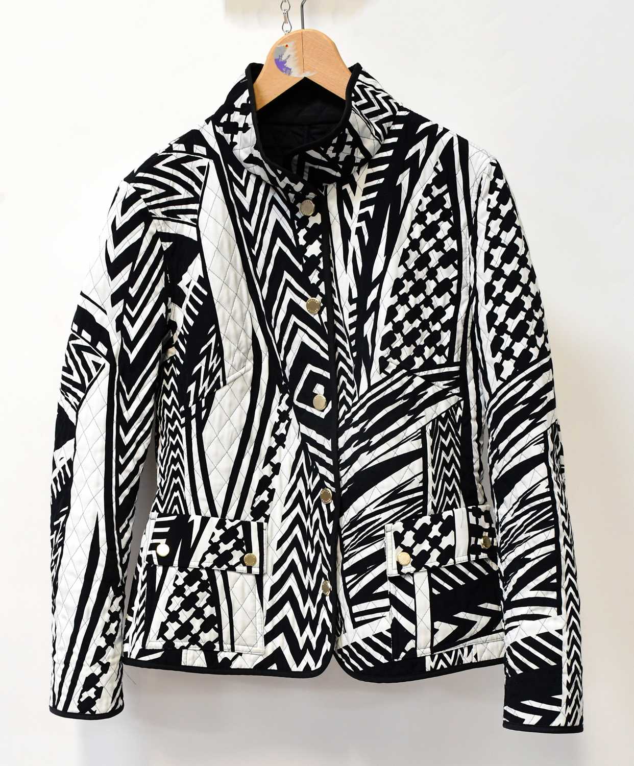 Lot 353 - A black and white quilted jacket, a Jaeger