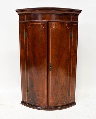 Lot 60 - A mahogany line inlaid bow-fronted two-door...