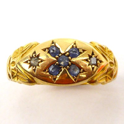 Lot 1003 - An 18ct gold ring with cross-shaped pattern,...