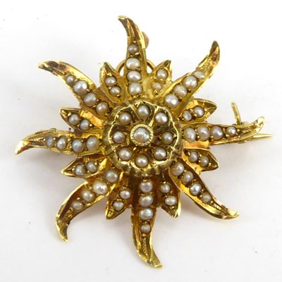 Lot 1045 - A 14k gold starburst brooch with small seed...