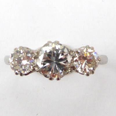 Lot 974 - A platinum ring set with three graduated claw...