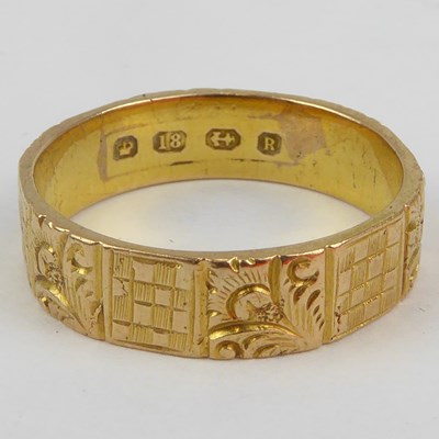 Lot 991 - An 18ct gold wedding band with repeating cut...