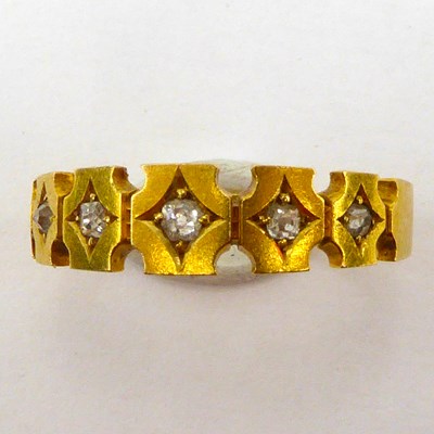 Lot 995 - An 18ct gold band ring, the shaped head set...