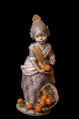 Lot 77 - LLADRO; a model of an Oriental girl holding...