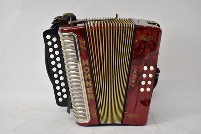 Lot 340 - A Hohner Erica accordion with red marble...