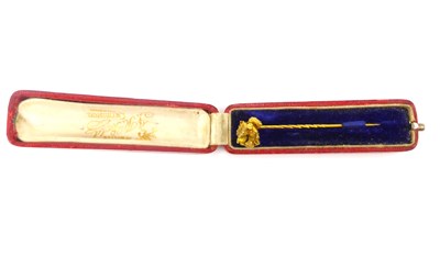 Lot 1054 - A gold pin with gold nugget attached at the...