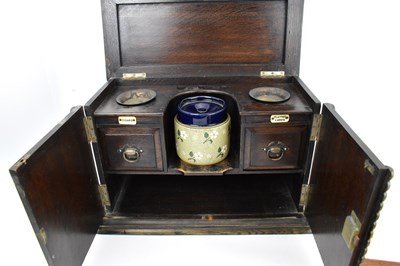 Lot 172 - A vintage oak smokers' cabinet with pottery...