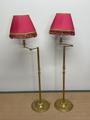 Lot 329 - A pair of brass floor lamps with pleated...