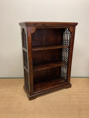 Lot 779 - A reproduction oak bookcase with pierced sides...