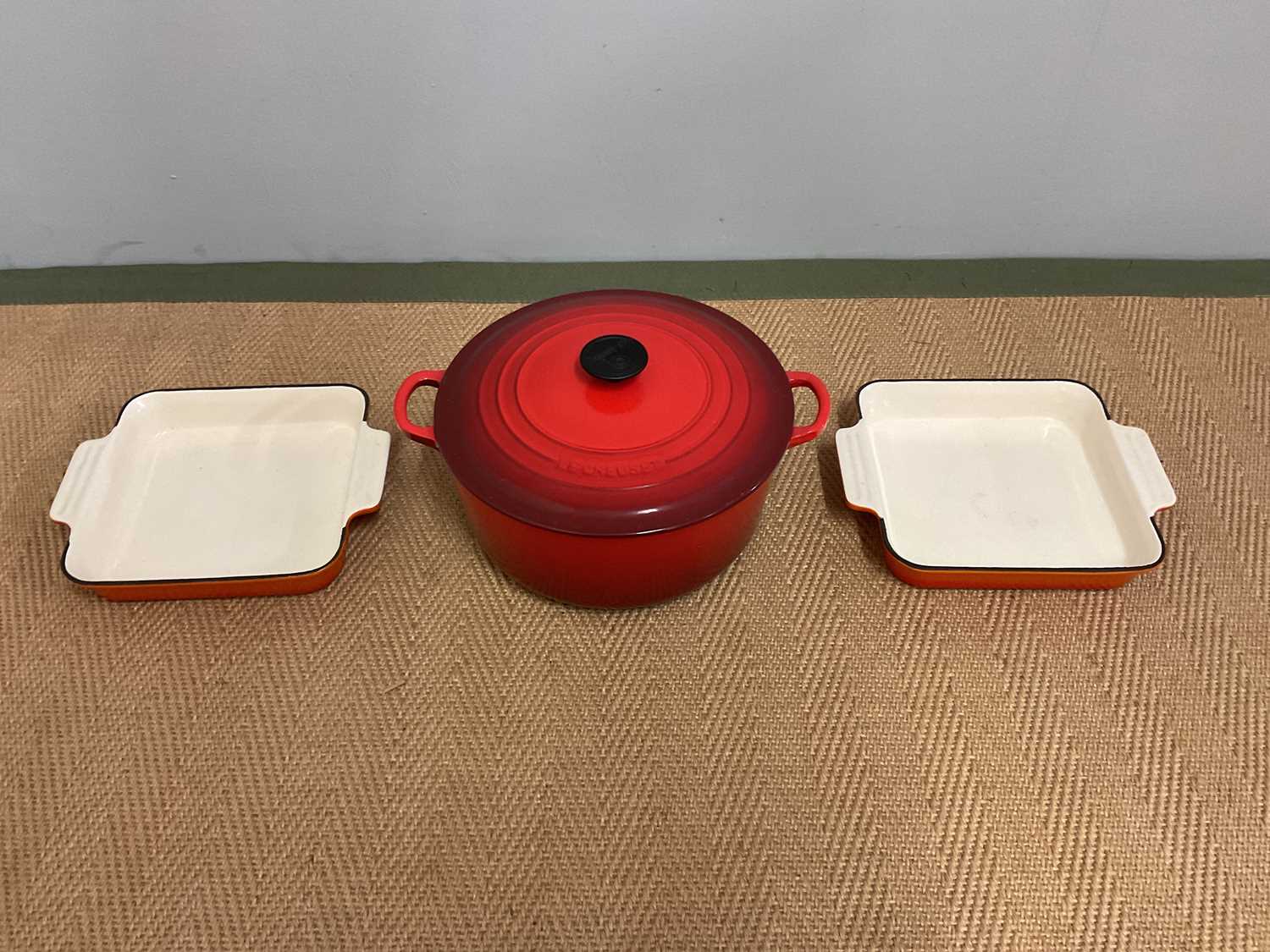 Lot 99 - LE CREUSET; a cast iron large casserole and...