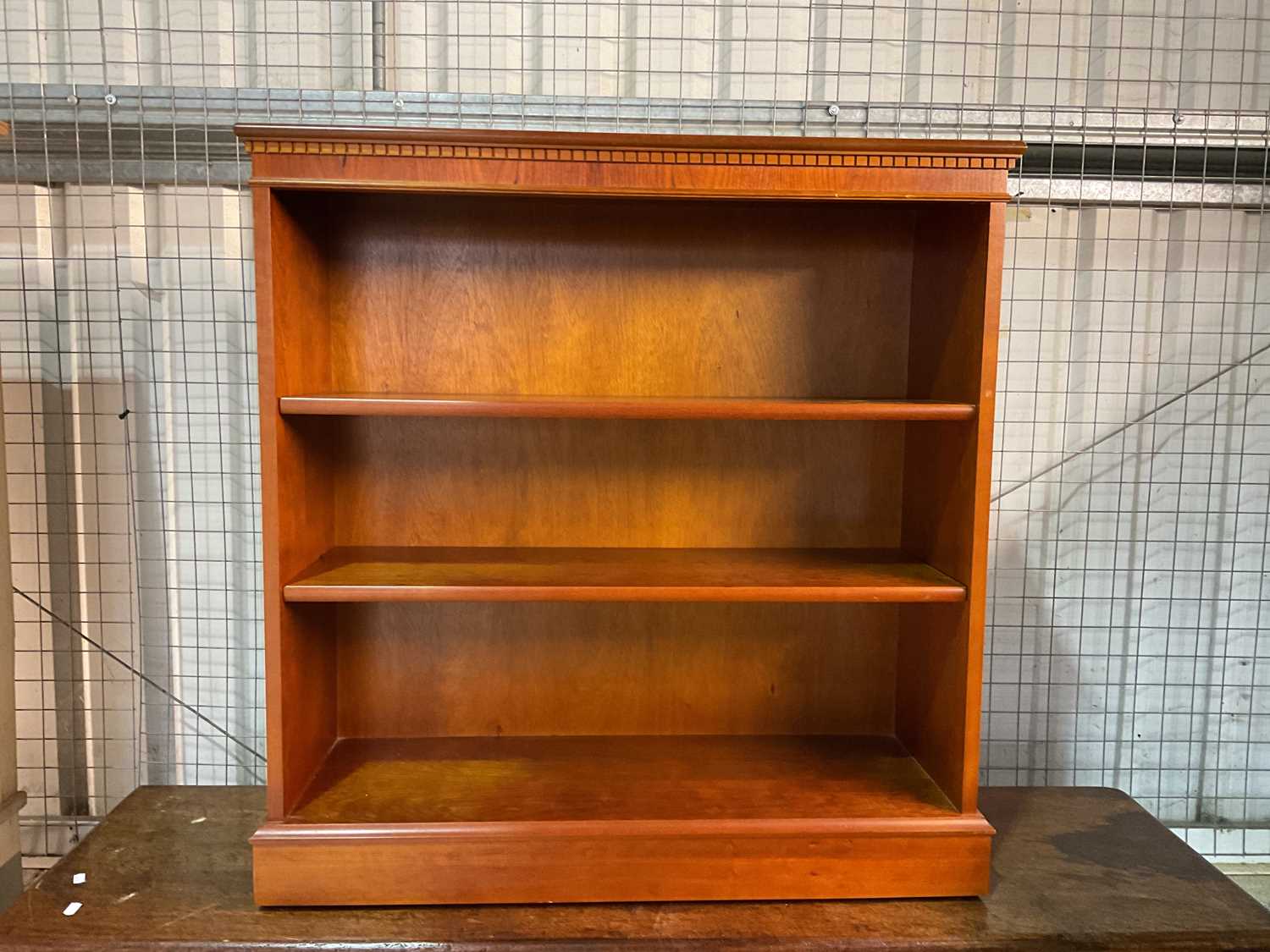 Lot 778 - A reproduction open bookcase with plinth base,...