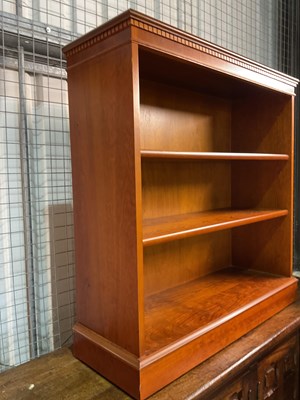 Lot 778 - A reproduction open bookcase with plinth base,...