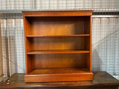 Lot 778 - A reproduction open bookcase with plinth base,...