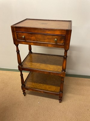Lot 775 - A reproduction three tiered hall table with...