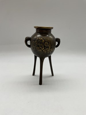 Lot 229 - A small Chinese bronze tripod censer, height...