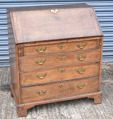 Lot 17 - An 18th century oak bureau with fall front...