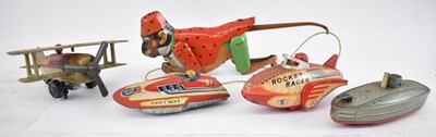 Lot 303 - A group of tinplate toys, to include rocket...