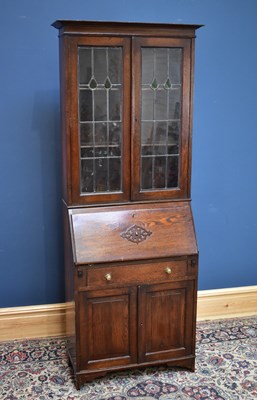 Lot 2596 - An early 20th century oak bureau bookcase, the...