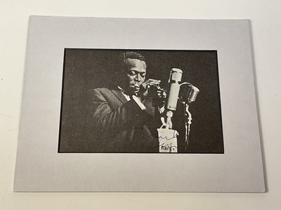 Lot 2316 - MILES DAVIS; a black and white magazine...