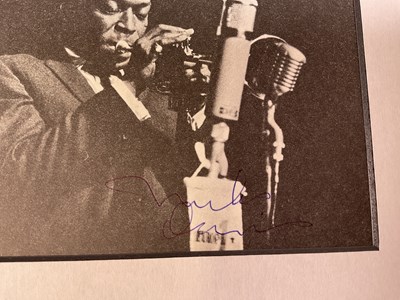 Lot 2316 - MILES DAVIS; a black and white magazine...