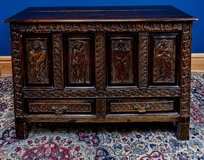 Lot 2540 - A 19th century oak coffer, the front carved 'I...