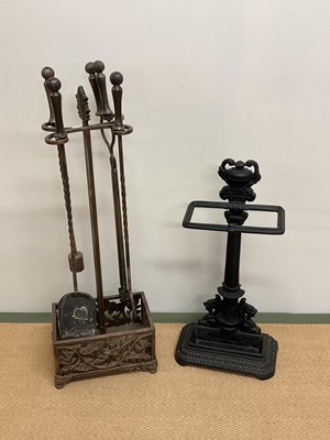 Lot 104 - A fireside companion set and an umbrella stand.