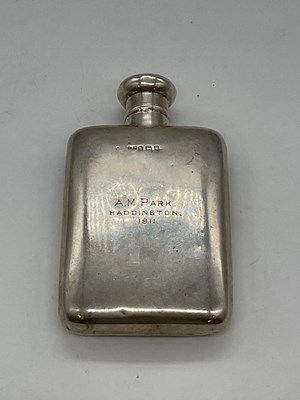 Lot 1097 - An Edwardian hallmarked silver hip flask with...