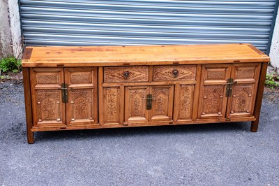 Lot 2571 - A Chinese stained pine and elm low sideboard,...