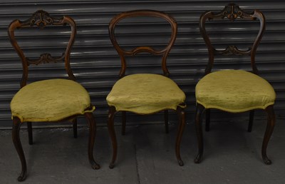 Lot 124 - A pair of Victorian walnut balloon back chairs...