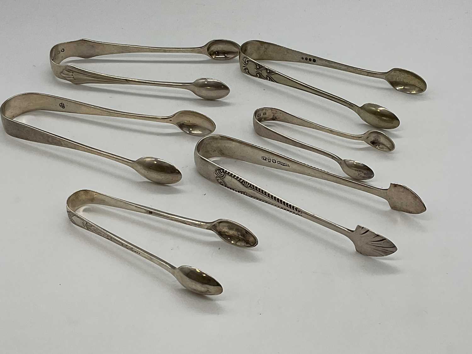 Lot 1045 Five pairs of hallmarked silver sugar tongs