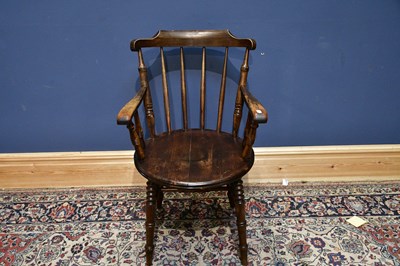 Lot 2475 - A 19th century elm seated spindle back elbow...