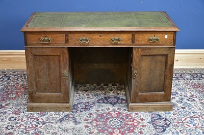 Lot 2402 - An early 20th century oak twin pedestal knee...