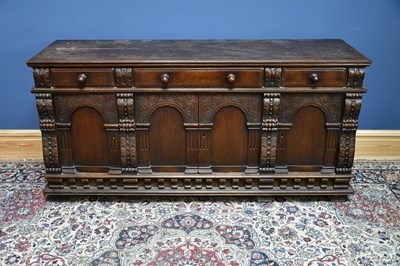 Lot 2583 - A reproduction carved oak sideboard, three...