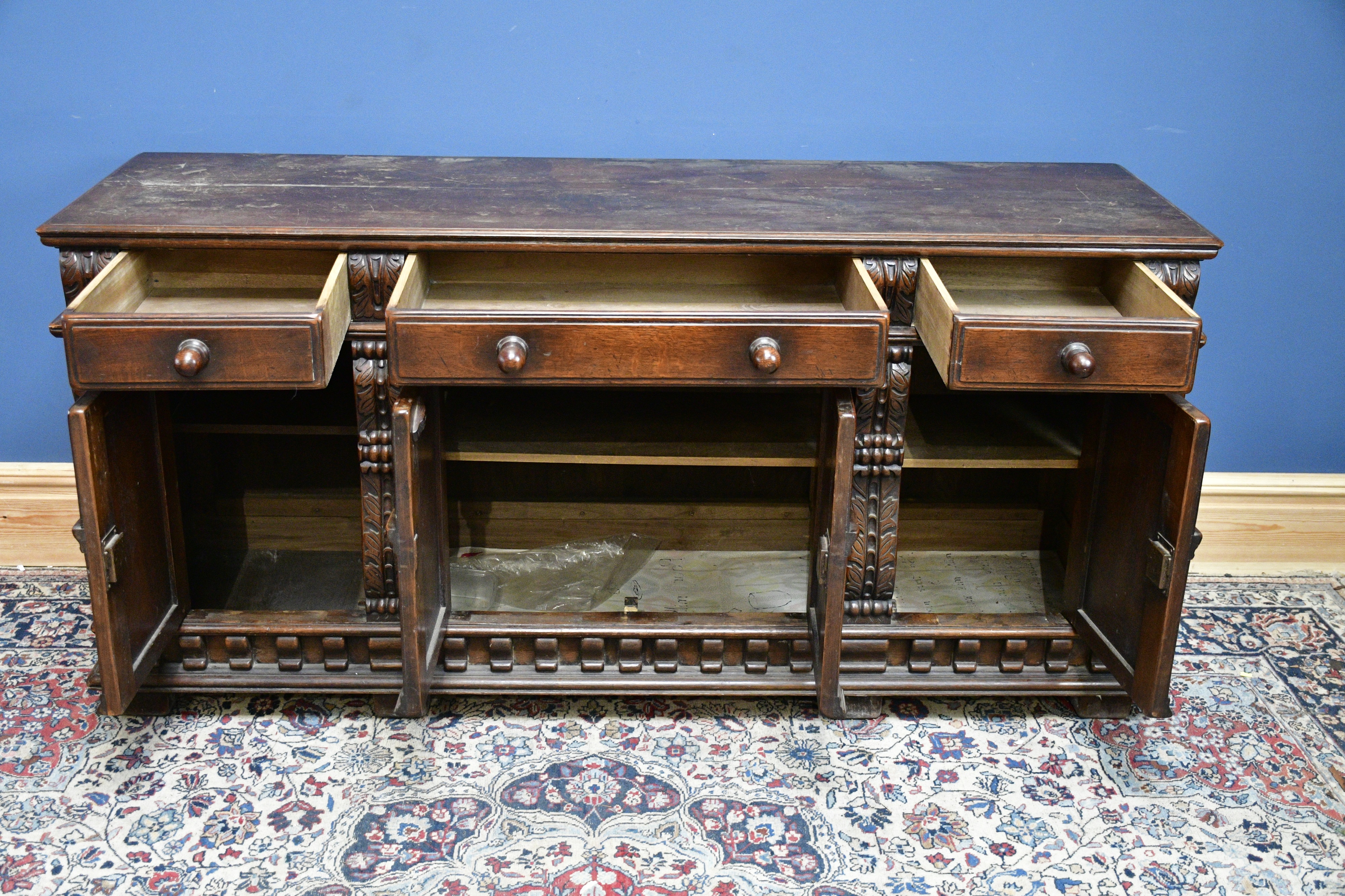Lot 2583 - A reproduction carved oak sideboard, three