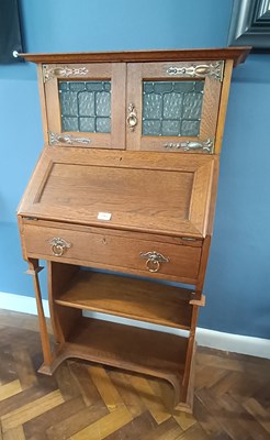 Lot 2562 - An Arts and Crafts oak bookcase, with two...