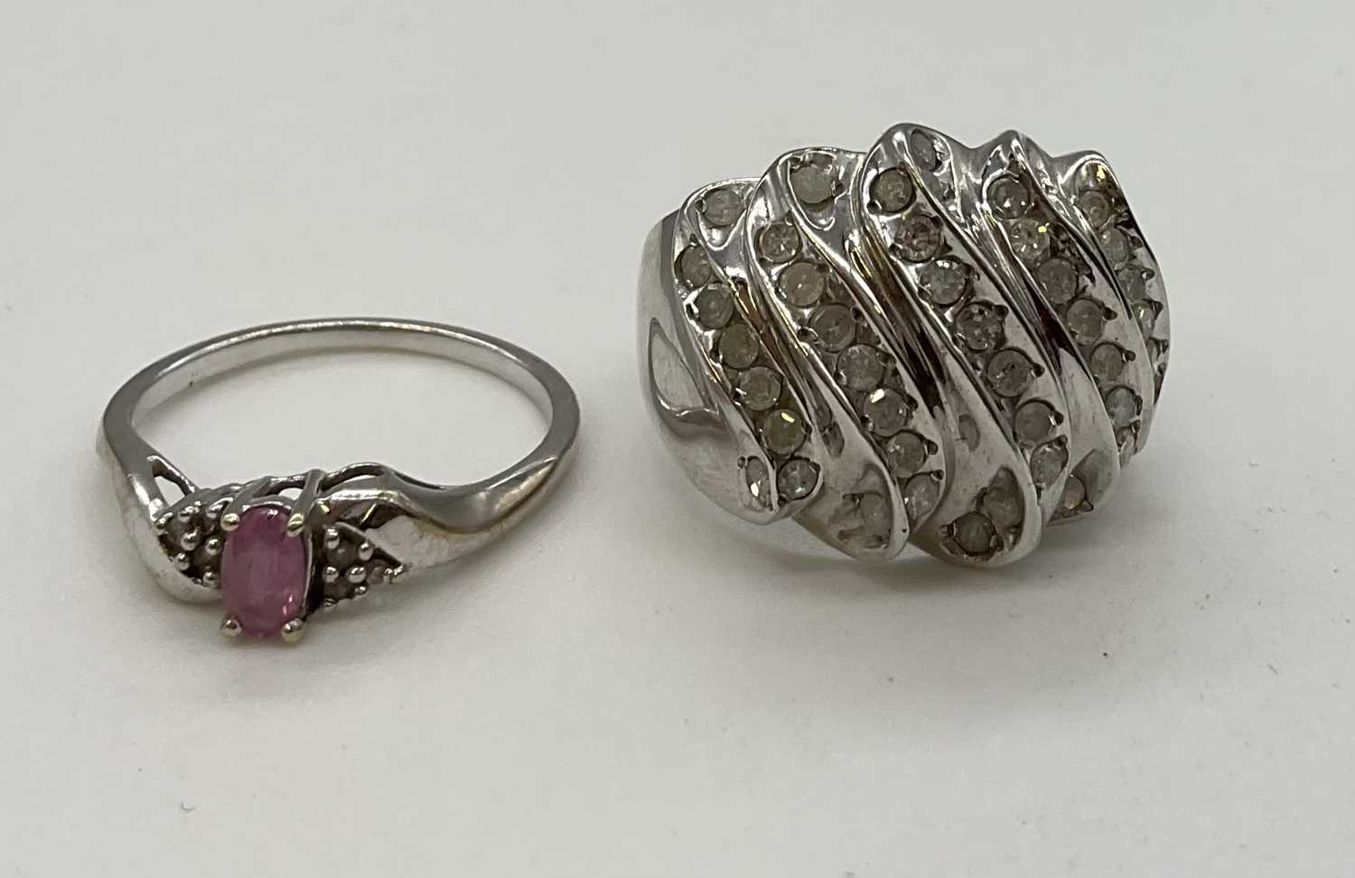 Lot 1216 - Two 9ct white gold dress rings, the larger...