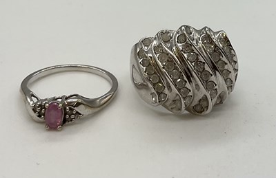 Lot 1216 - Two 9ct white gold dress rings, the larger...