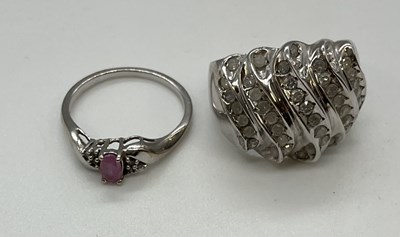 Lot 1216 - Two 9ct white gold dress rings, the larger...