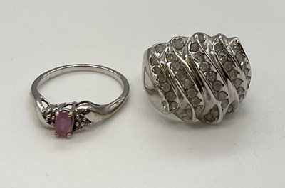 Lot 1216 - Two 9ct white gold dress rings, the larger...