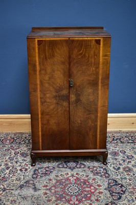 Lot 2415 - A 1950s walnut tallboy, with two cupboard...