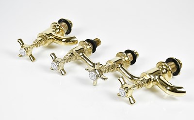 Lot 1071 - A group of four brass tap fittings.