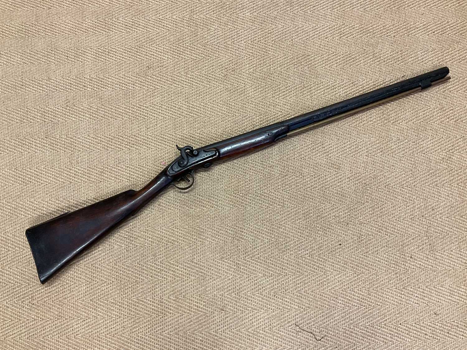 Lot 72 - A 19th Century flintlock rifle with mahogany...