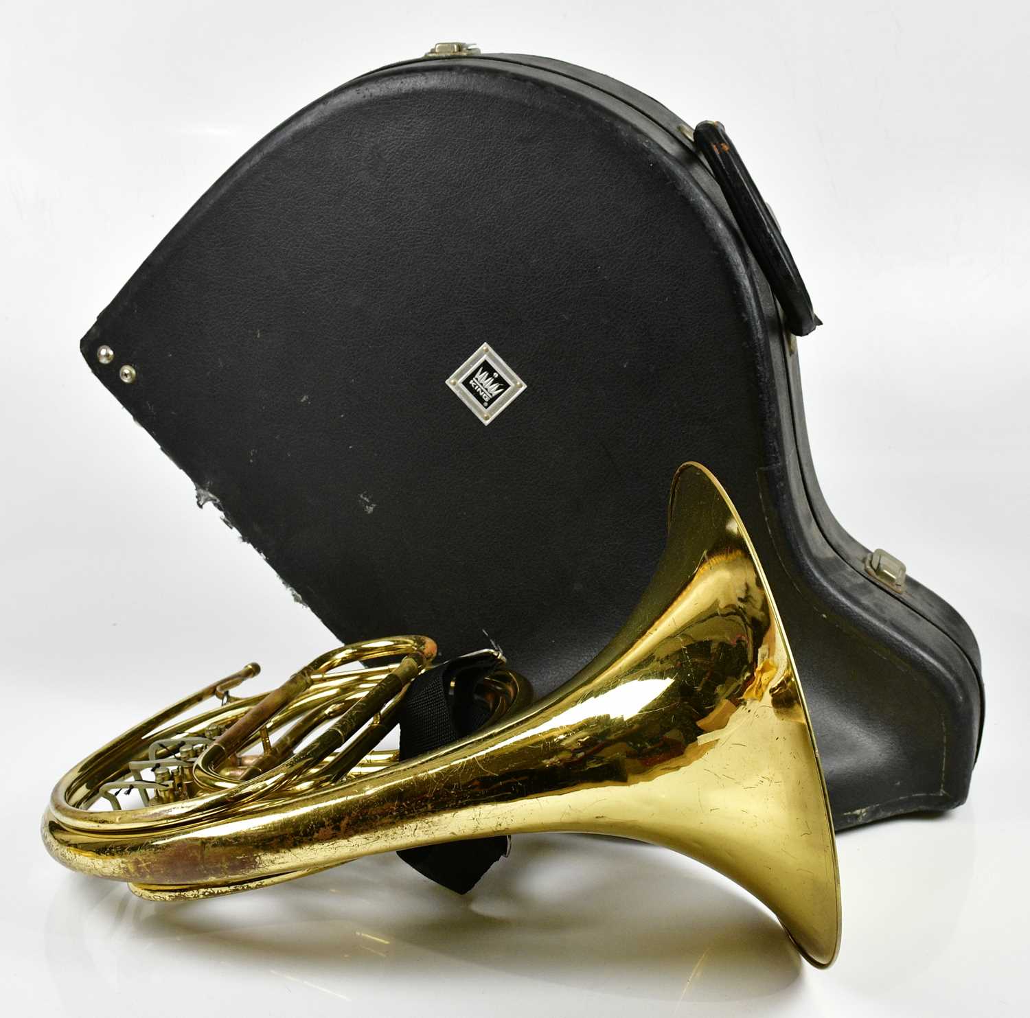 Lot 1165 - CLEVELAND; a brass plated French horn, cased.