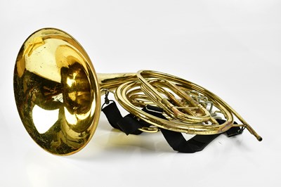 Lot 1165 - CLEVELAND; a brass plated French horn, cased.