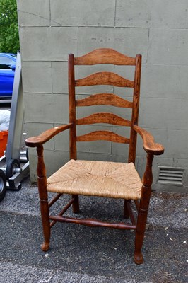 Lot 2547 - A 19th century rush seated ladder back elbow...