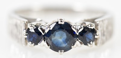 Lot 165 - An 18ct white gold and sapphire three stone...