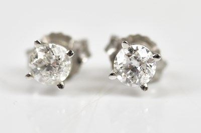 Lot 651 - A pair of diamond ear studs, each set with...