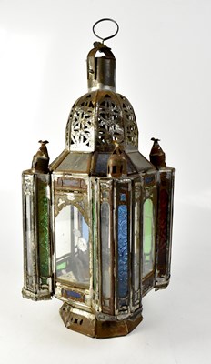 Lot 116 - A large ornate Moroccan metal and glass candleholder