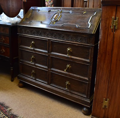 Lot 2416 - A 1920s oak bureau with fall front over three...