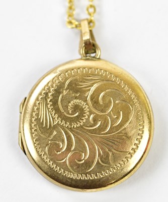 Lot 452 - A 9ct yellow gold circular engraved locket...